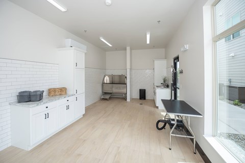 A kitchen with white cabinets and a black table.