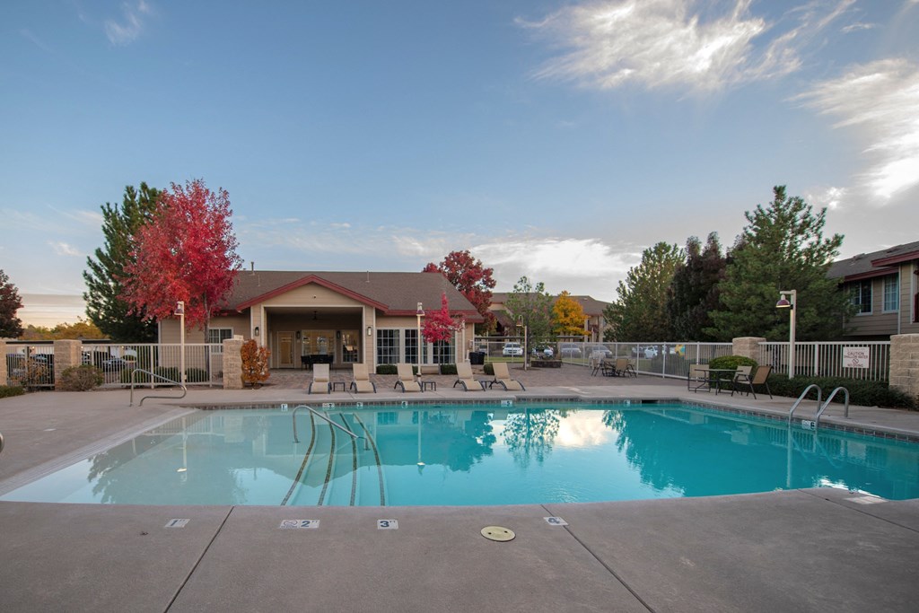 a swimming pool with a building in the background