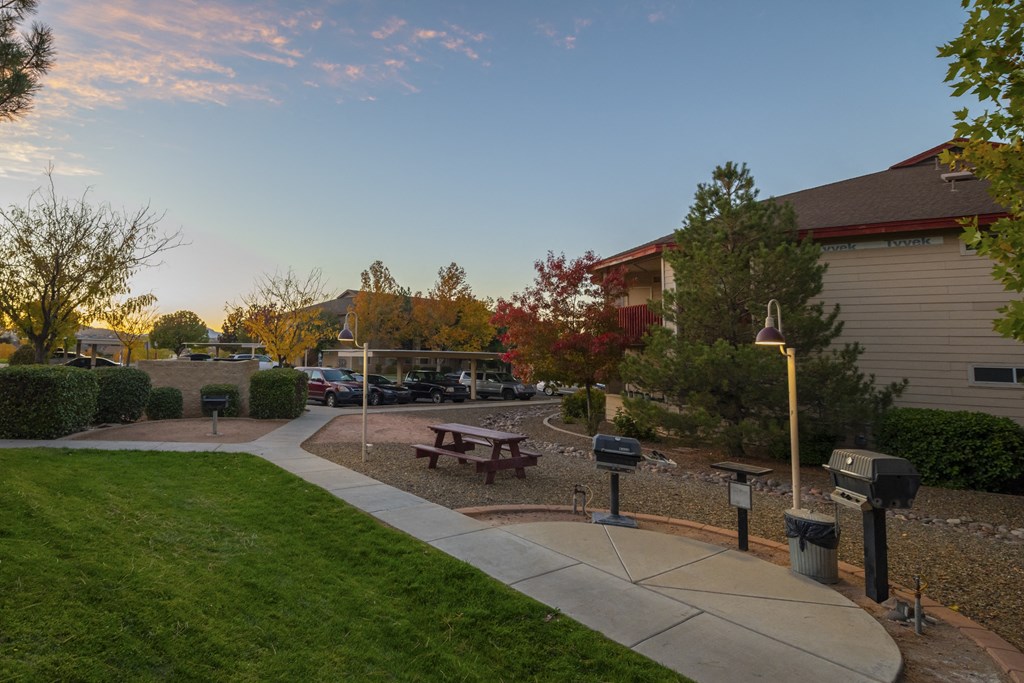 a park with a picnic table in front of a building