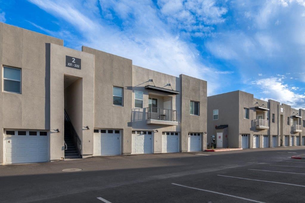 the exterior of a building with garage doors and a street at Inspiration Apartments, Cottonwood