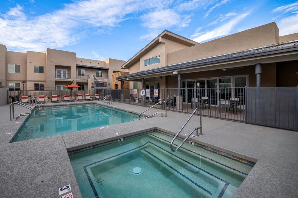a swimming pool with a building in the background at Inspiration Apartments, Cottonwood, AZ, 86326