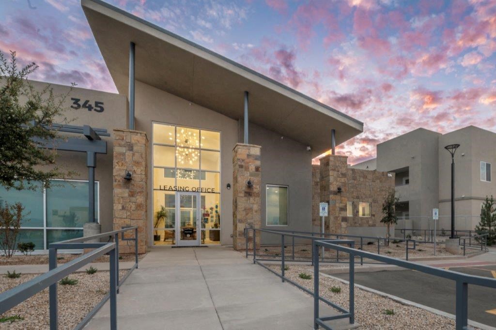 a building with a reflection of the sky in the window at Inspiration Apartments, Arizona