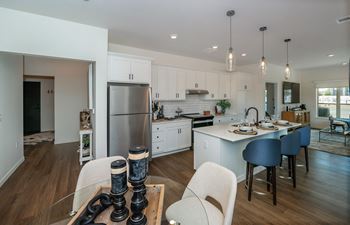 A modern kitchen with white cabinets and a large island.