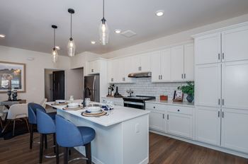 A modern kitchen with a dining table and chairs.