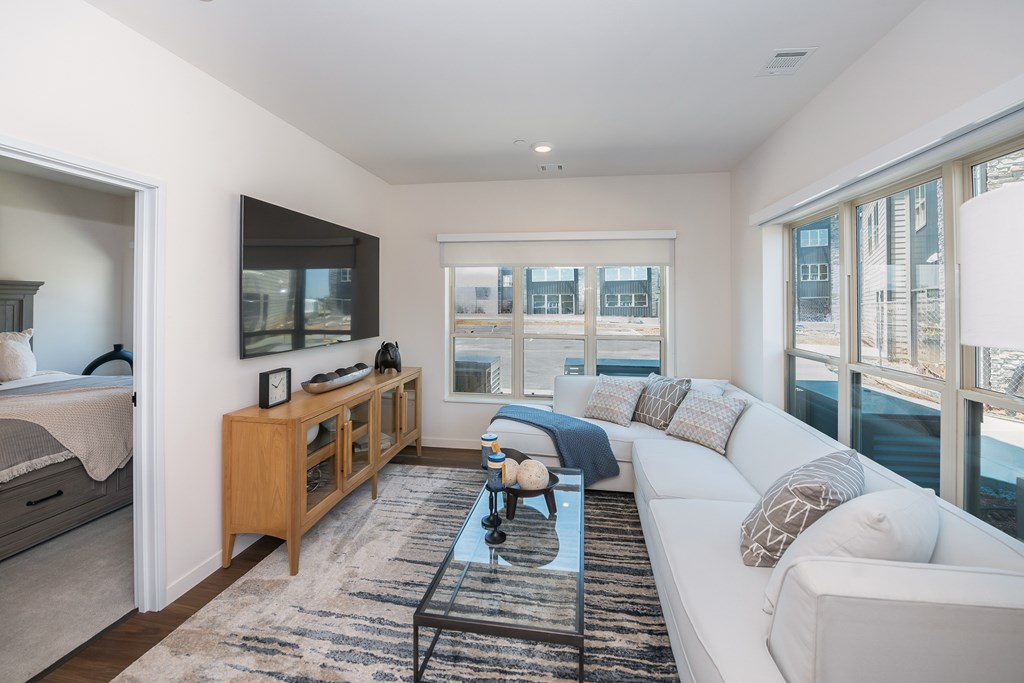 a living room with a white couch and a television at The Crossings  at Windsong, Prescott Valley, AZ