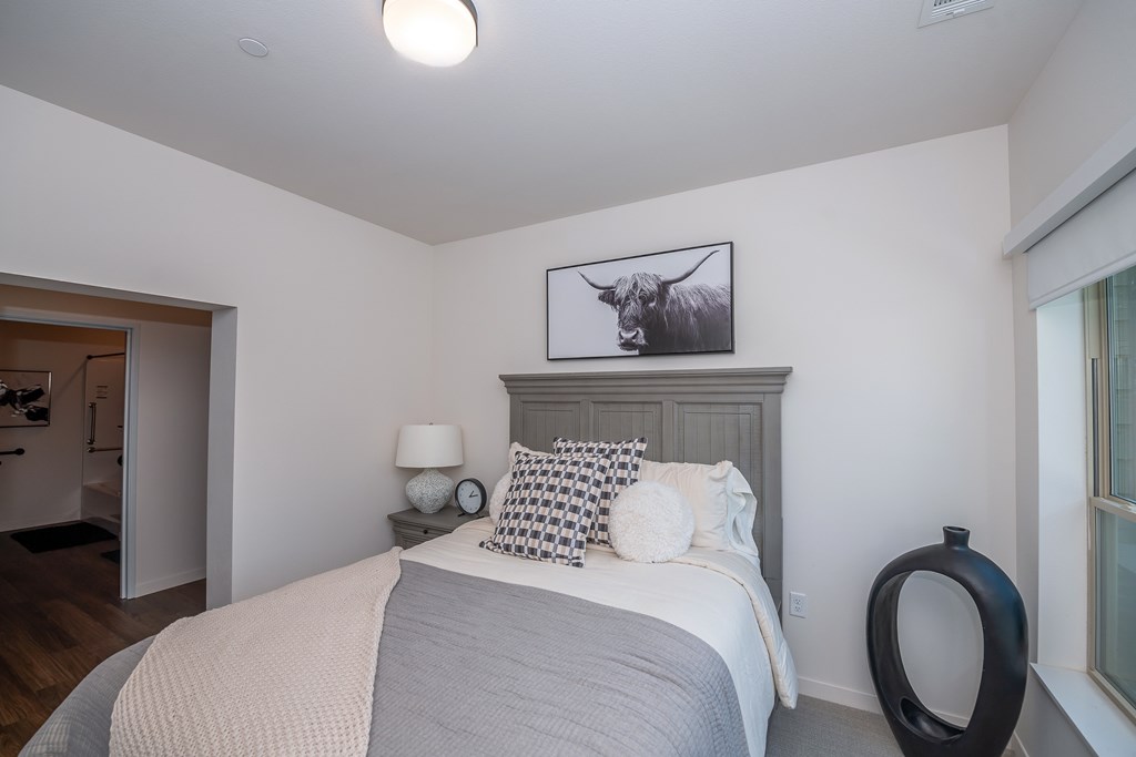bedroom with white walls and a bed with blue and white pillows bedroom with white walls and a bed with blue and white pillows at The Crossings at Windsong, Prescott Valley