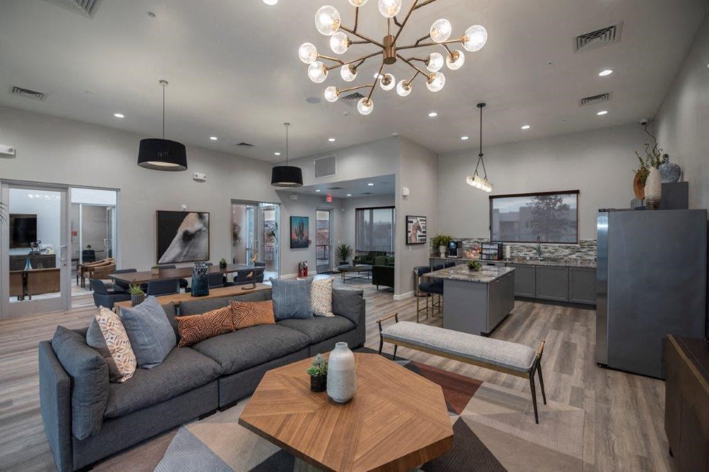 a living room with couches and a table and a chandelier at Inspiration Apartments, Cottonwood