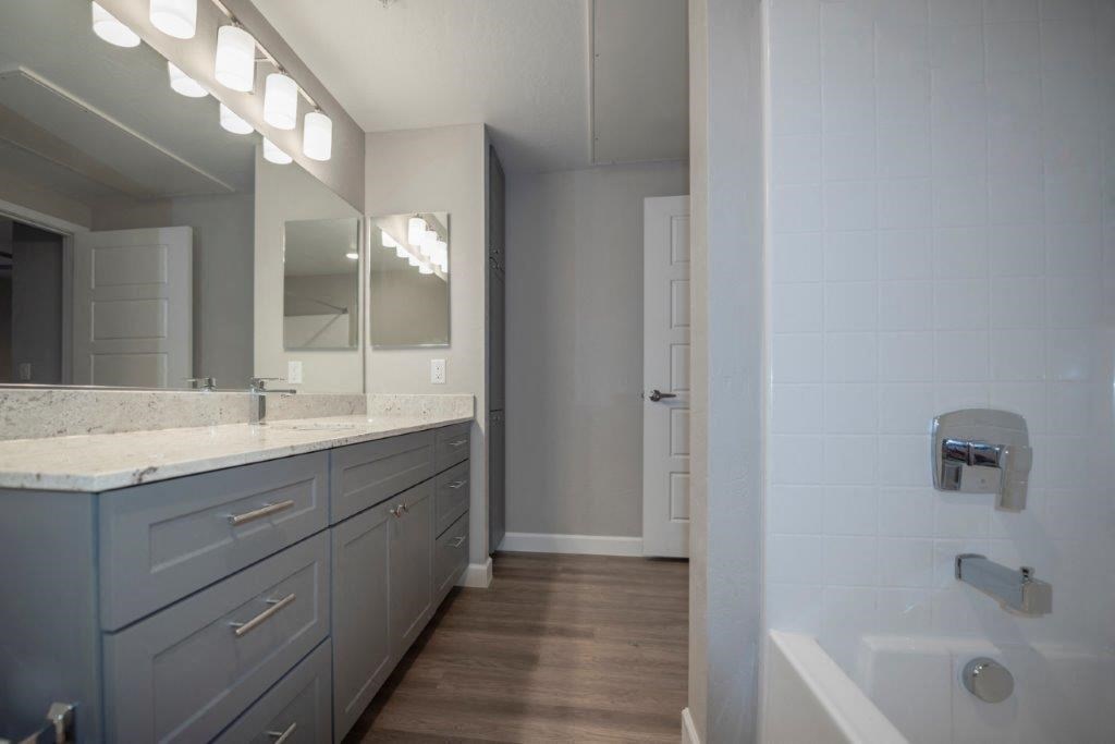 a bathroom with a shower and a sink and a mirror at Inspiration Apartments, Cottonwood, AZ