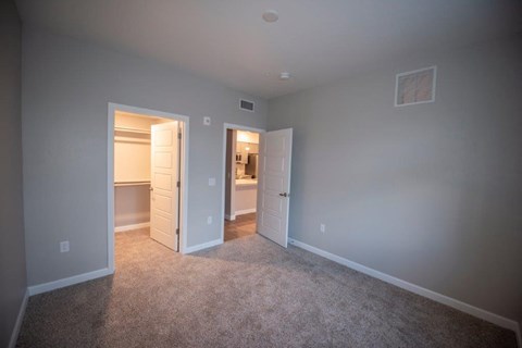 a bedroom with a closet and a door to a bathroom at Inspiration Apartments, Cottonwood, AZ, 86326