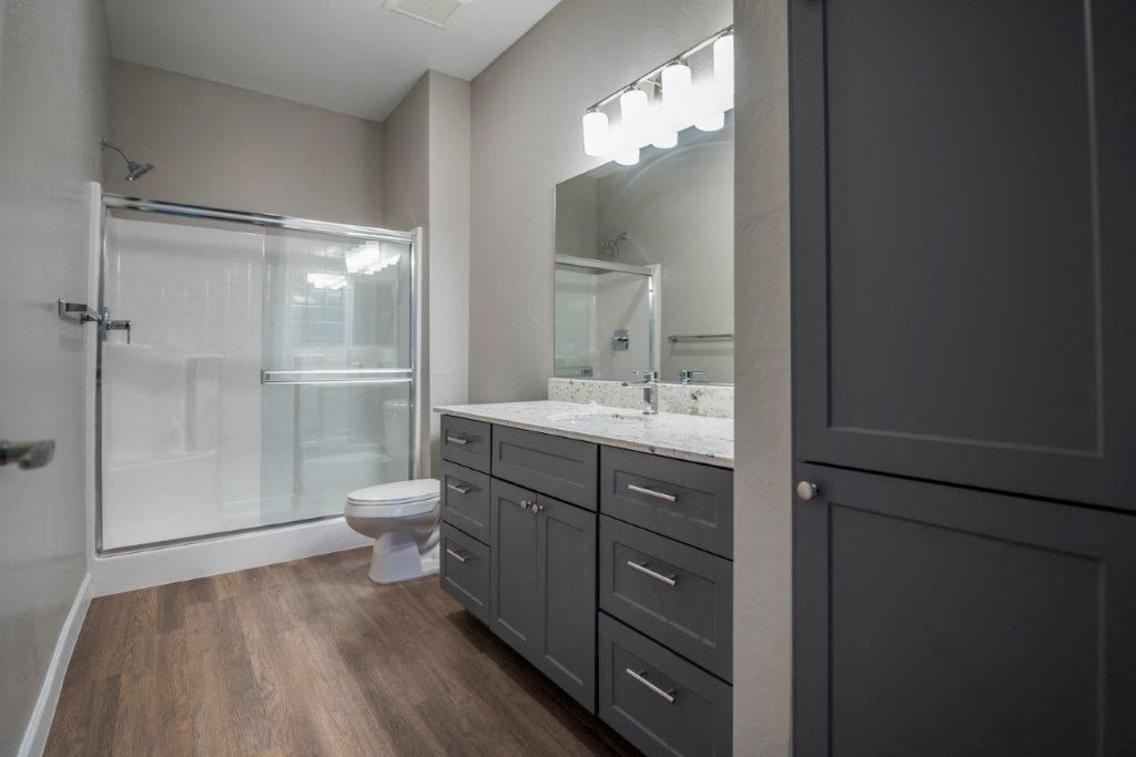a bathroom with a shower and a sink and a mirror at Inspiration Apartments, Arizona