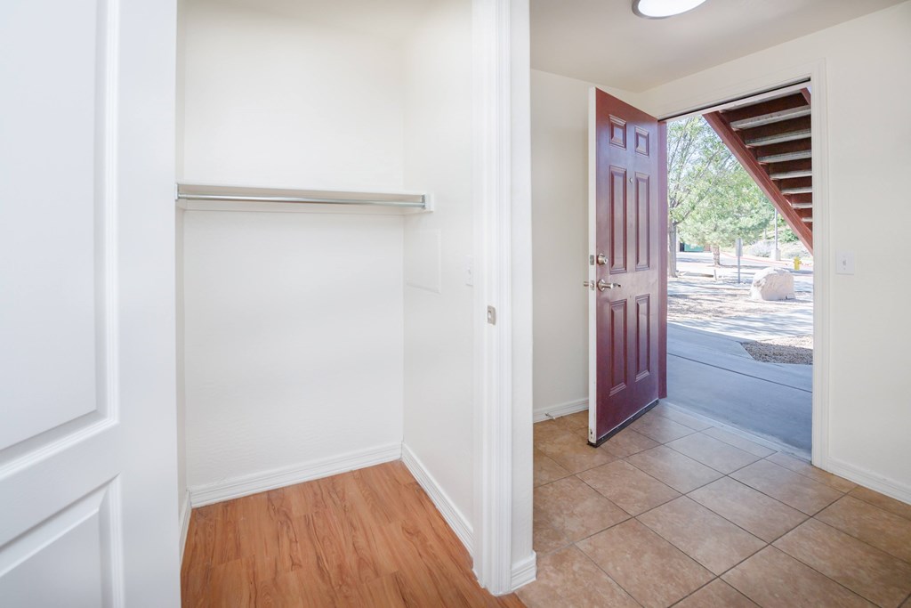 A room with a white door and a red door.