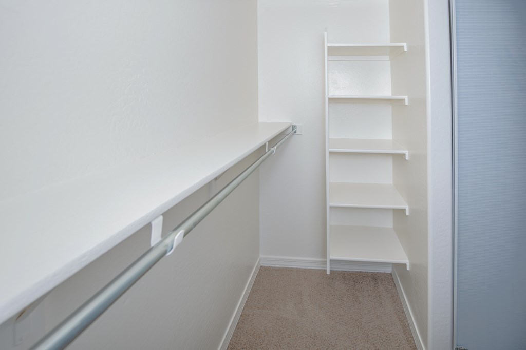 A white staircase with a metal handrail.