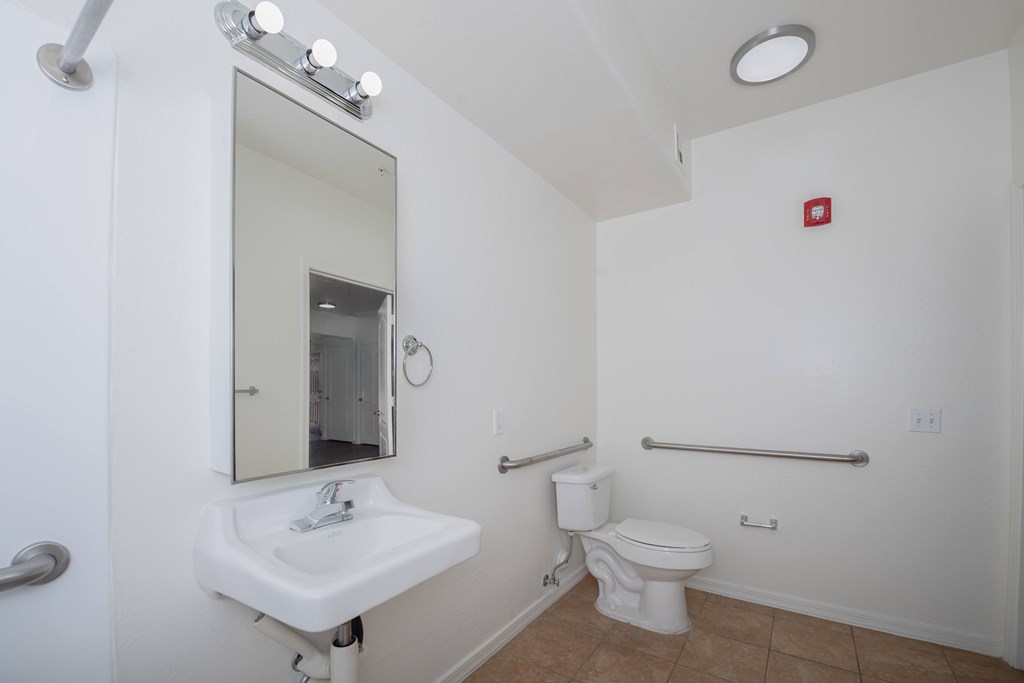 A white sink and toilet in a small bathroom.