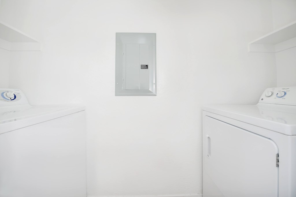 A white washing machine and dryer in a laundry room.