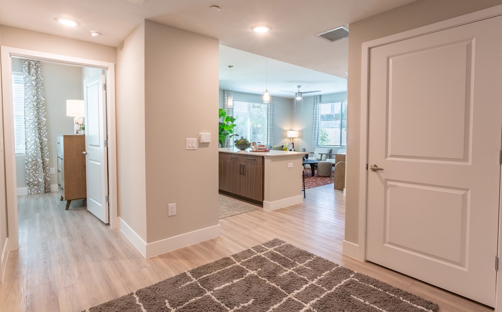 A modern kitchen with a dining area and a living room.