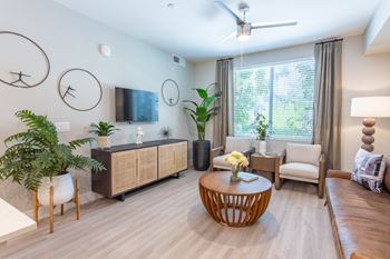 A living room with a wooden floor and furniture.