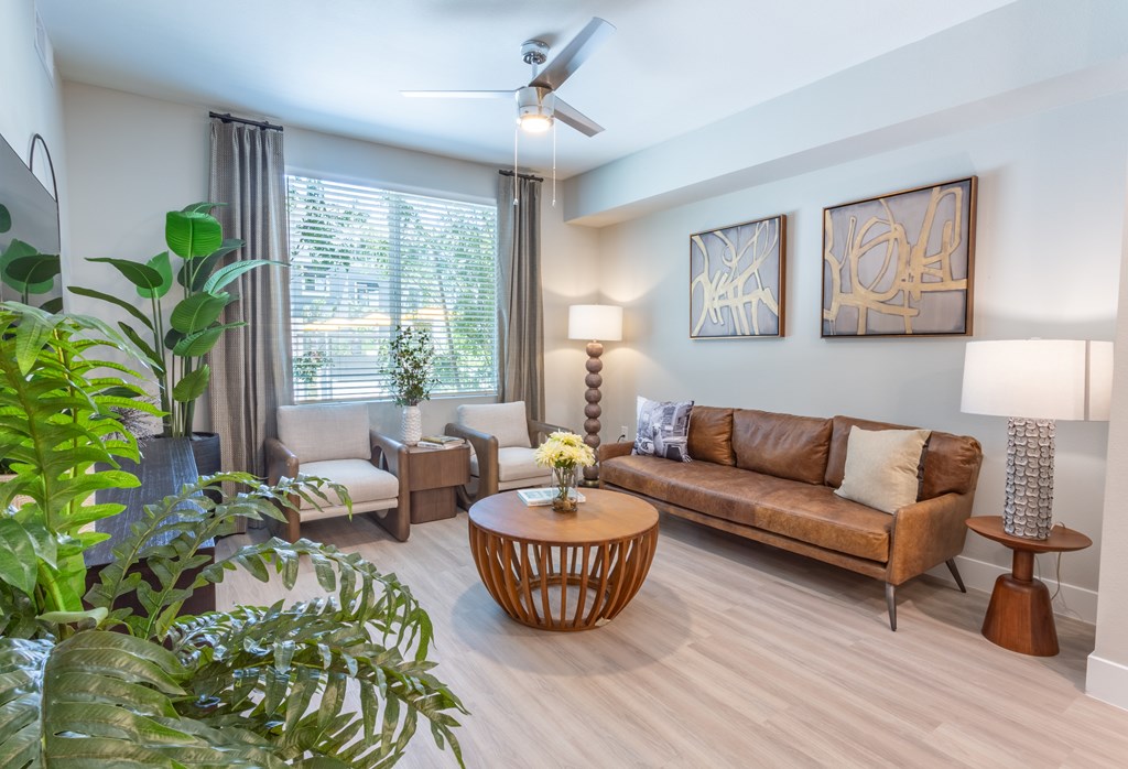 Luxury Apartments In North Phoenix, AZ With In-Unit Washer And Dryer - The Amelia - Living Area With Smart Home Technology, Open Concept Floor Plans, And Ceiling Fan.