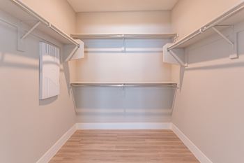 A white wall with a shelf and a white radiator on it.