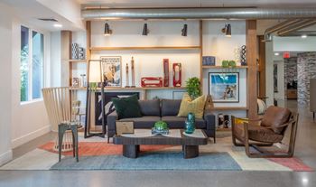 A modern living room with a grey couch and a coffee table.