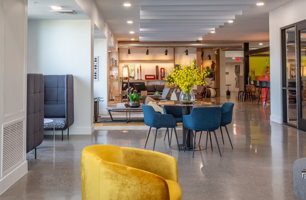 A dining area with a table surrounded by chairs.
