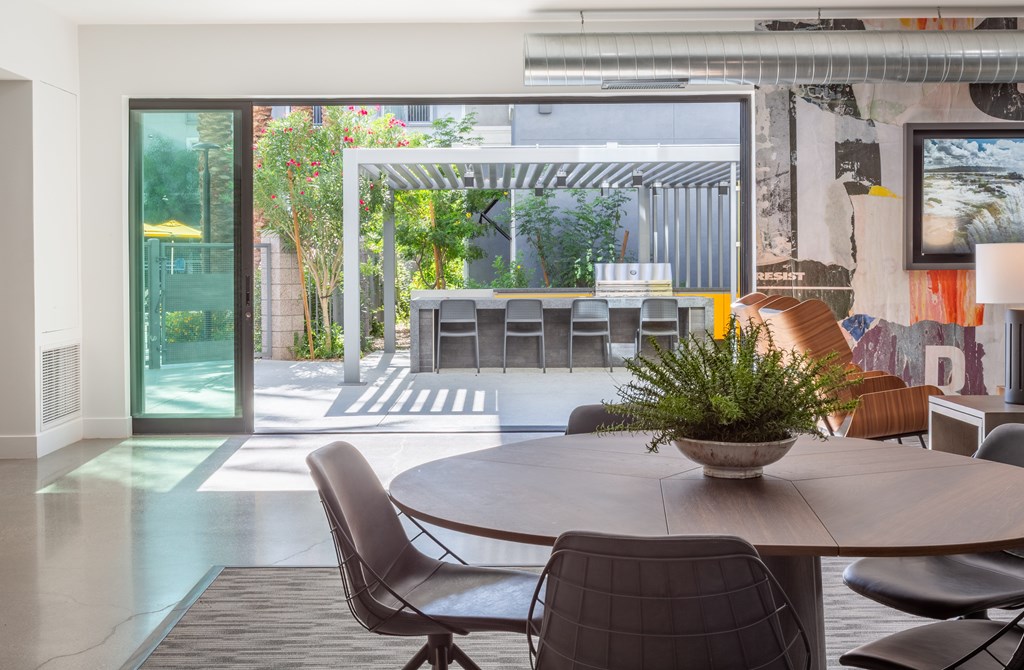 A modern dining room with a table and chairs.
