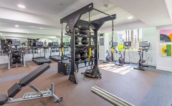 A gym with a variety of equipment including a leg press machine.