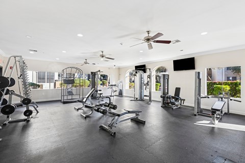 A spacious gym with a variety of equipment.