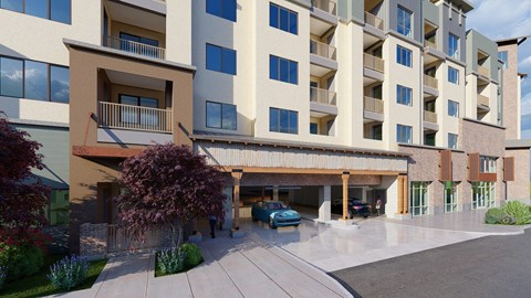 A modern apartment building with a parking area in front.