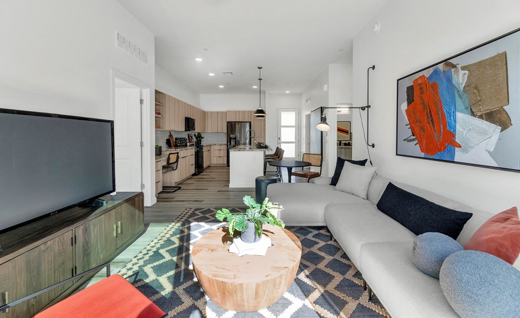 A living room with a white couch and a television on a wooden stand.at Marketside Villas at Verrado, Arizona, 85396