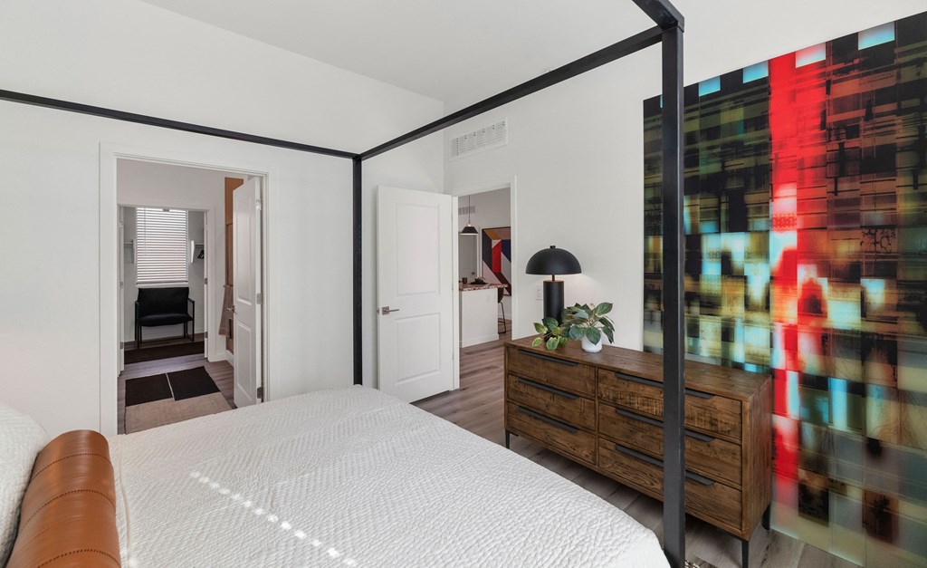 A bedroom with a large bed and a dresser.at Marketside Villas at Verrado, Arizona, 85396