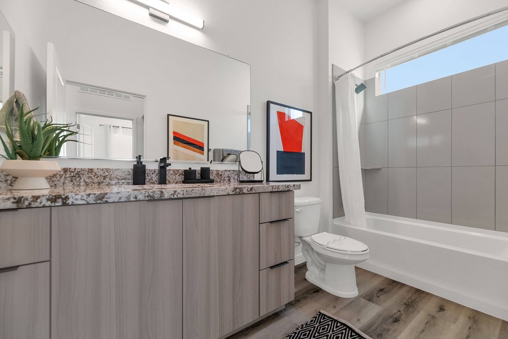 A bathroom with a marble countertop and a white toilet.at Marketside Villas at Verrado, Buckeye, AZ
