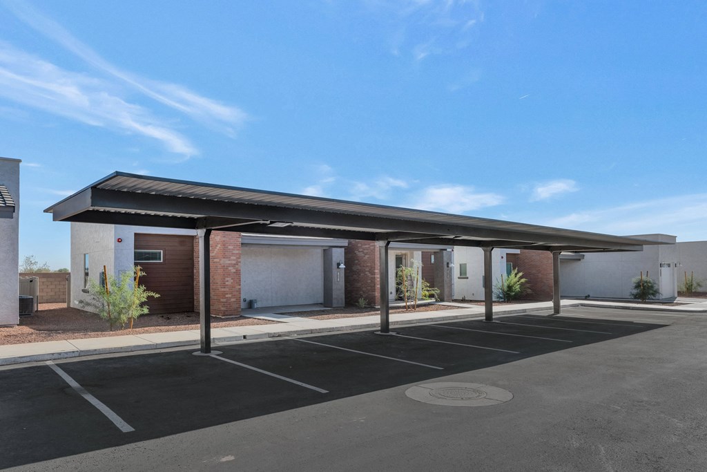 A parking lot with a building in the background.at Marketside Villas at Verrado, Buckeye, AZ