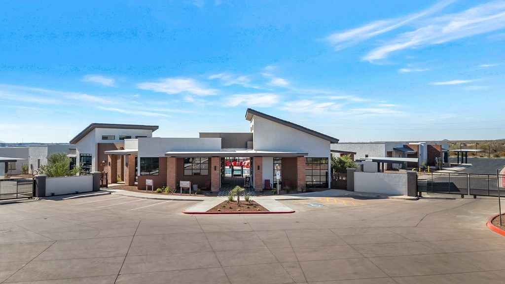 A building with a parking lot in front of it.at Marketside Villas at Verrado, Arizona