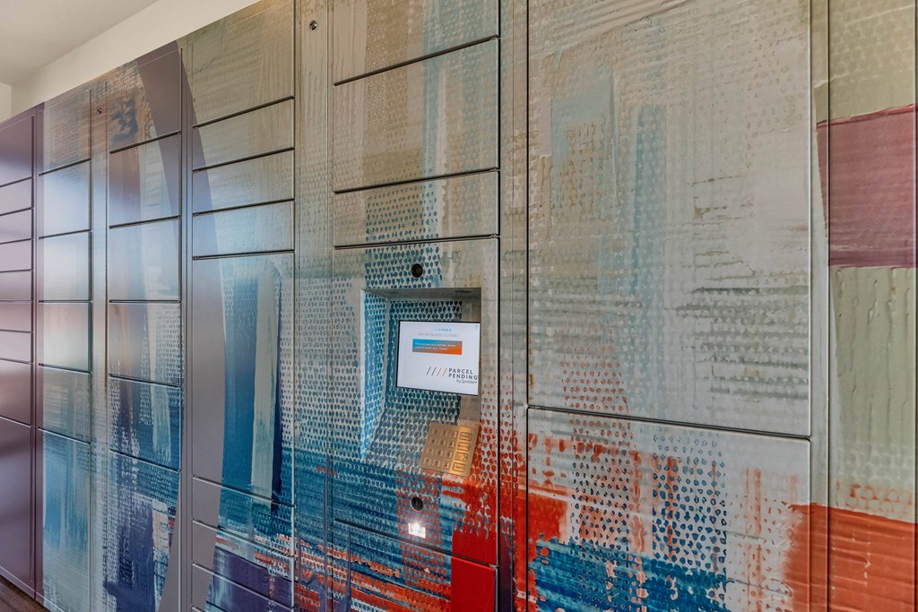 A wall with a pattern of squares and rectangles in different shades of blue, red, and white.at Marketside Villas at Verrado, Arizona