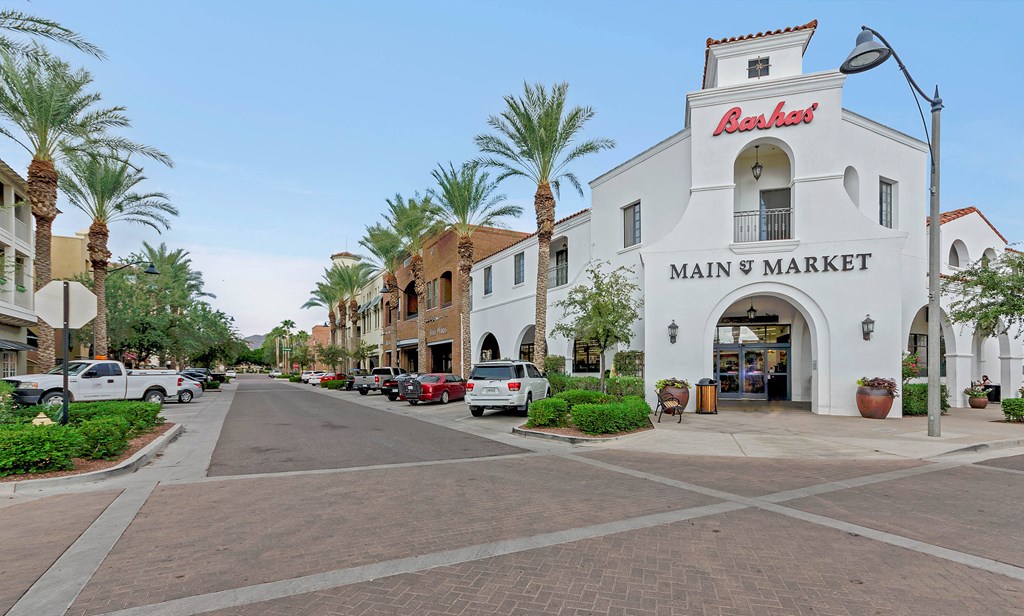 A white building with a red sign that says at Marketside Villas at Verrado, Buckeye, AZ, 85396