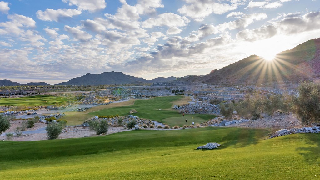 A golf course with a green lawn and a mountain in the background.at Marketside Villas at Verrado, Buckeye Arizona