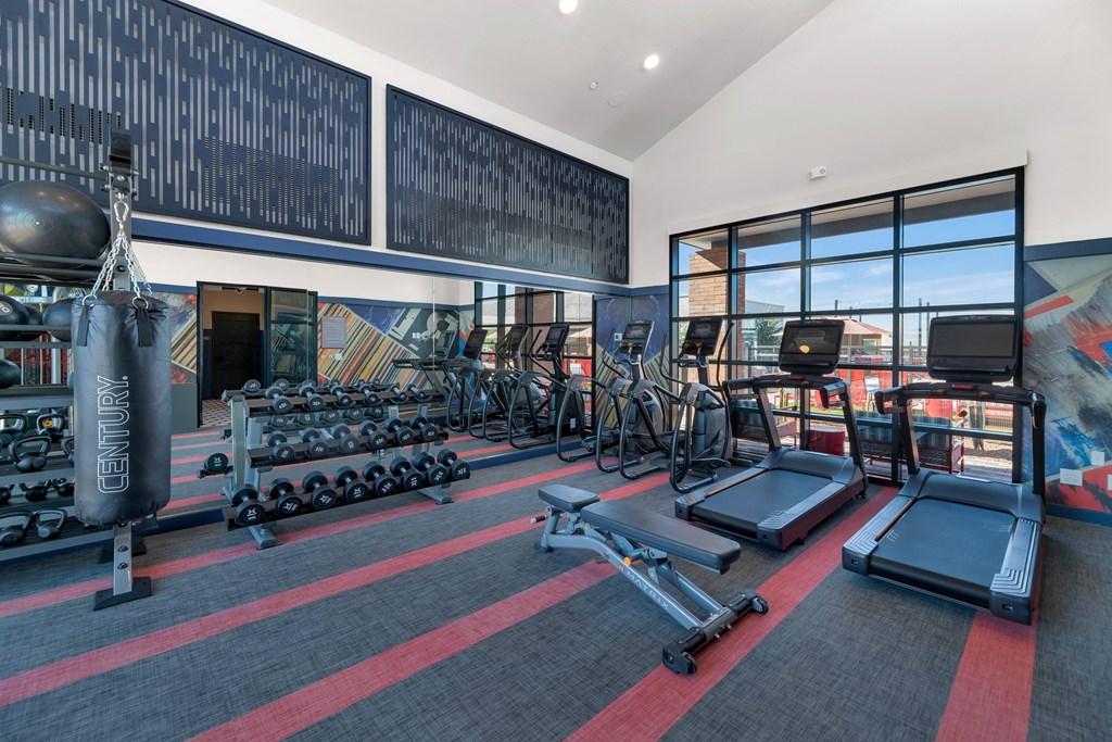 A gym with a variety of equipment including treadmills, weights, and exercise bikes.at Marketside Villas at Verrado, Arizona, 85396