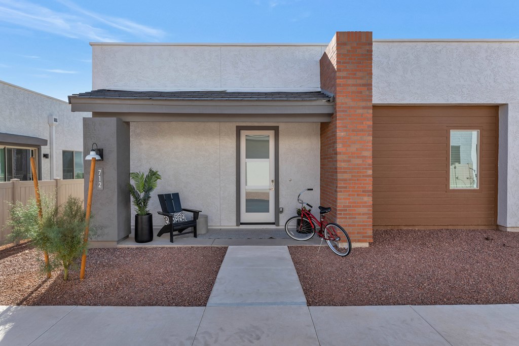 A modern house with a bicycle parked in front.at Marketside Villas at Verrado, Arizona