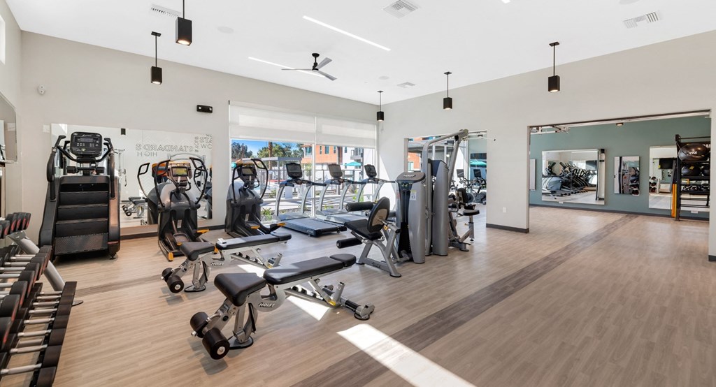 a gym with cardio machines and other exercise equipment at Melody on Main, Arizona, 85210