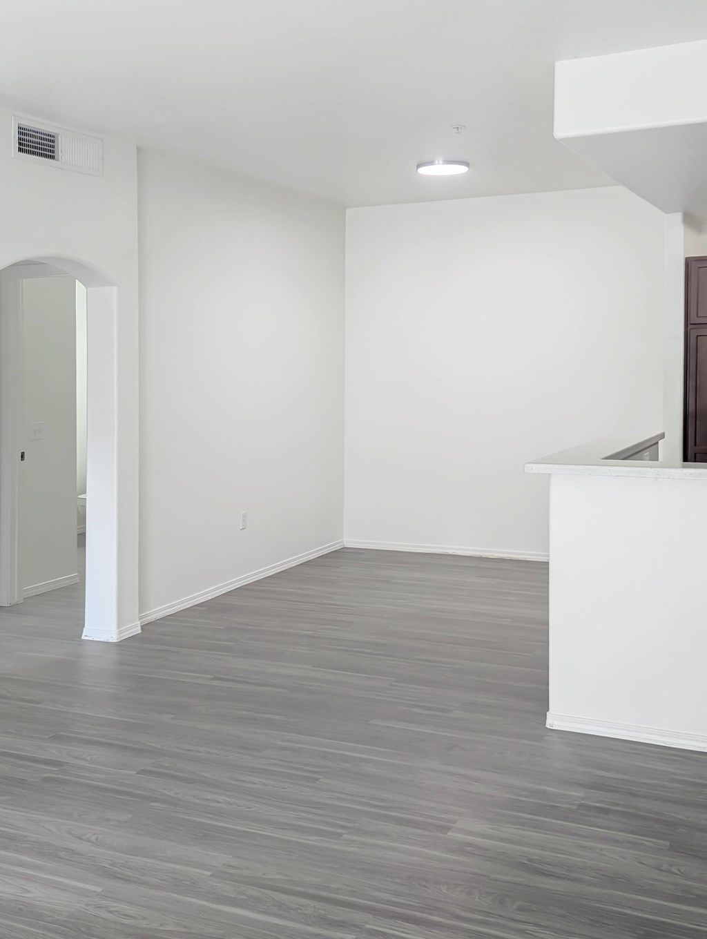 A room with a white wall and a wooden floor.