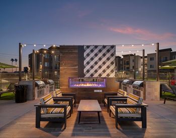 a rendering of a patio with a fire pit and chairs