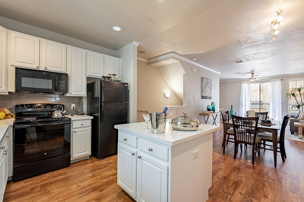 A kitchen with black appliances and white cabinets.at Palazzo Townhomes, Arizona, 85008