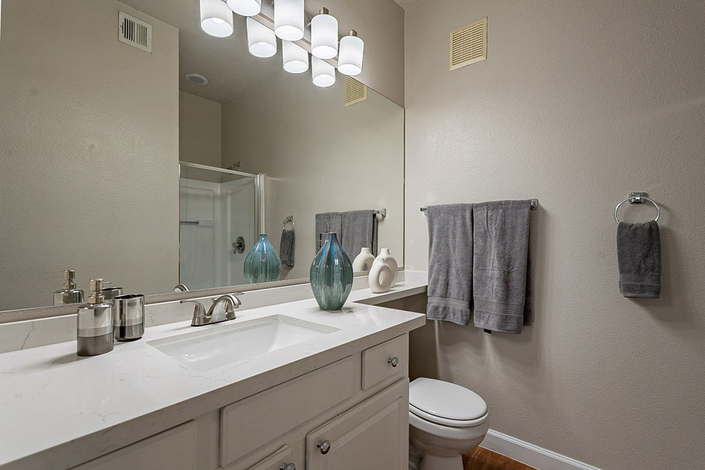 A bathroom with a white counter top and a white toilet.at Palazzo Townhomes, Arizona, 85008