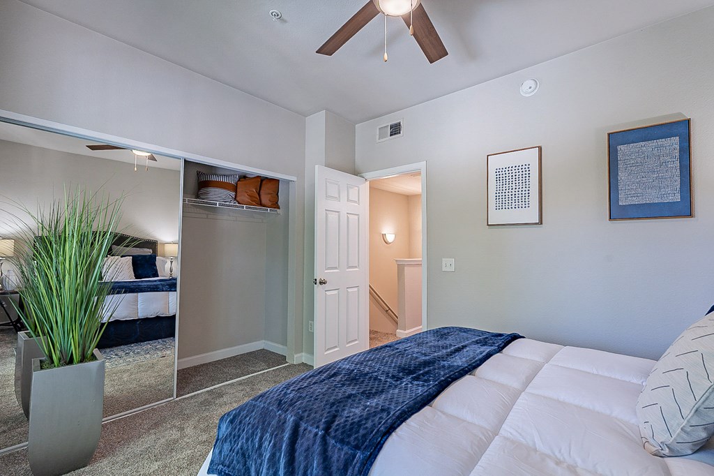 A bedroom with a bed, a ceiling fan, and a potted plant.at Palazzo Townhomes, Phoenix, 85008  