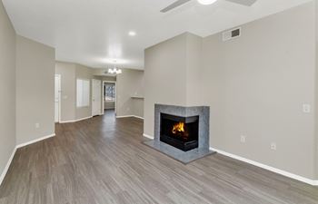 a living room with a fireplace and a hard wood floor