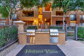 a barbecue grill in front of an apartment building