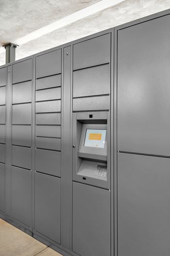A row of grey lockers with a keypad on the right one.