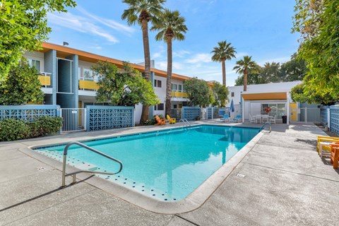 A swimming pool in a sunny outdoor setting.