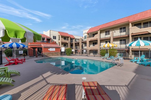 A pool area with a red and white striped mat in the foreground.