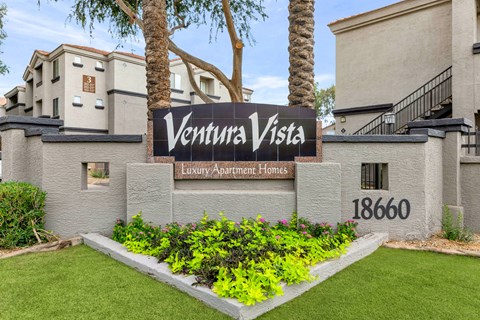 A sign that says Ventura Vista in front of a building.